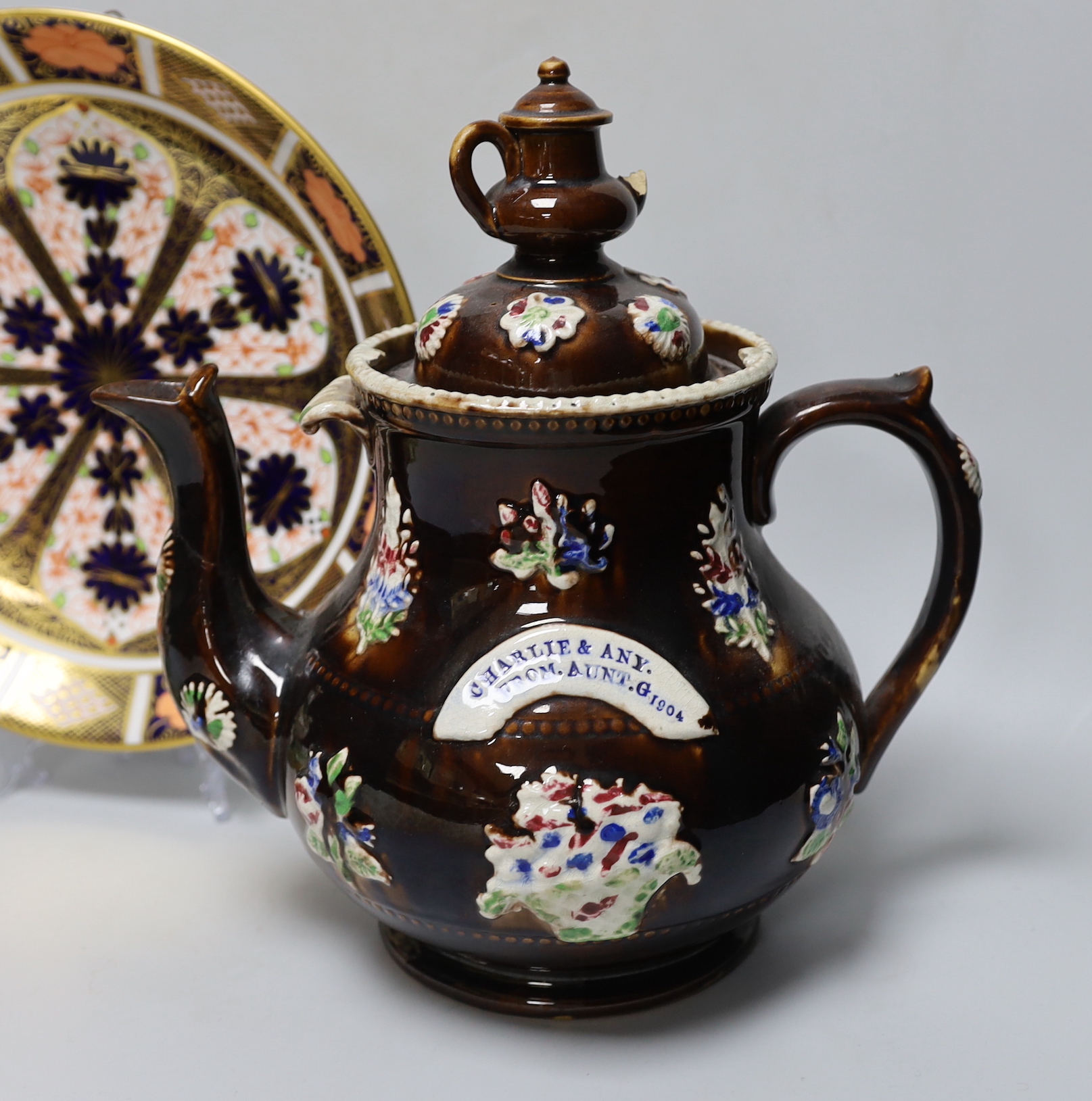 A Measham Bargeware teapot, a Derby Imari 1128 dish and an unusual Victorian Staffordshire group of a witch riding a goose, tallest 27cm